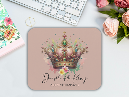 A floral notepad, keyboard, and pink roses surround a mouse pad featuring a decorative crown and the text "Daughter of the King, 2 Corinthians 6:18."