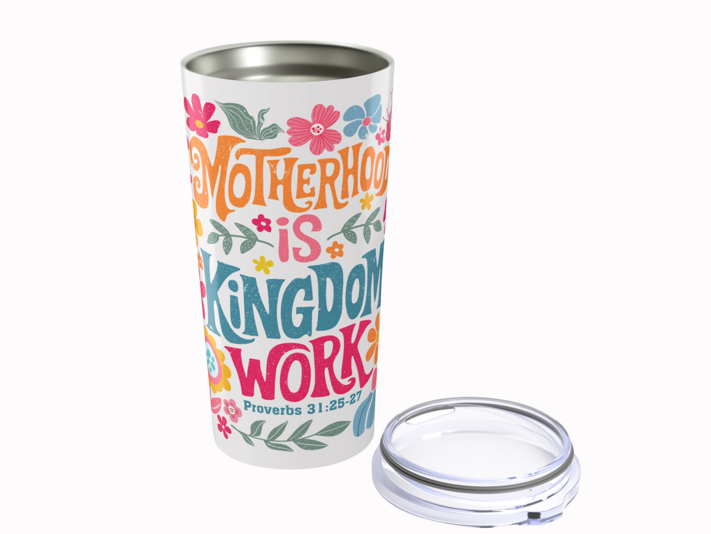 Tall travel mug with colorful text reading "Motherhood is Kingdom Work" along with floral designs. The lid is placed next to the tumbler.