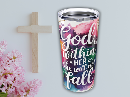 A wooden cross and pink flowers are next to a colorful travel mug with the phrase "God is within her, she will not fall." The tone is uplifting and spiritual.