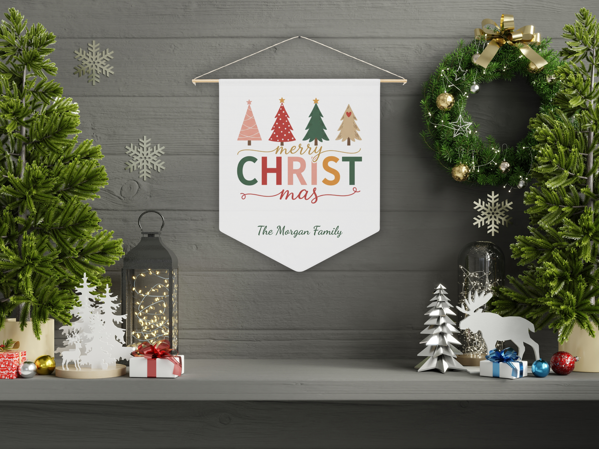Decorative Christmas banner with trees and 'Merry Christmas' text, hanging on a wall with festive decorations.