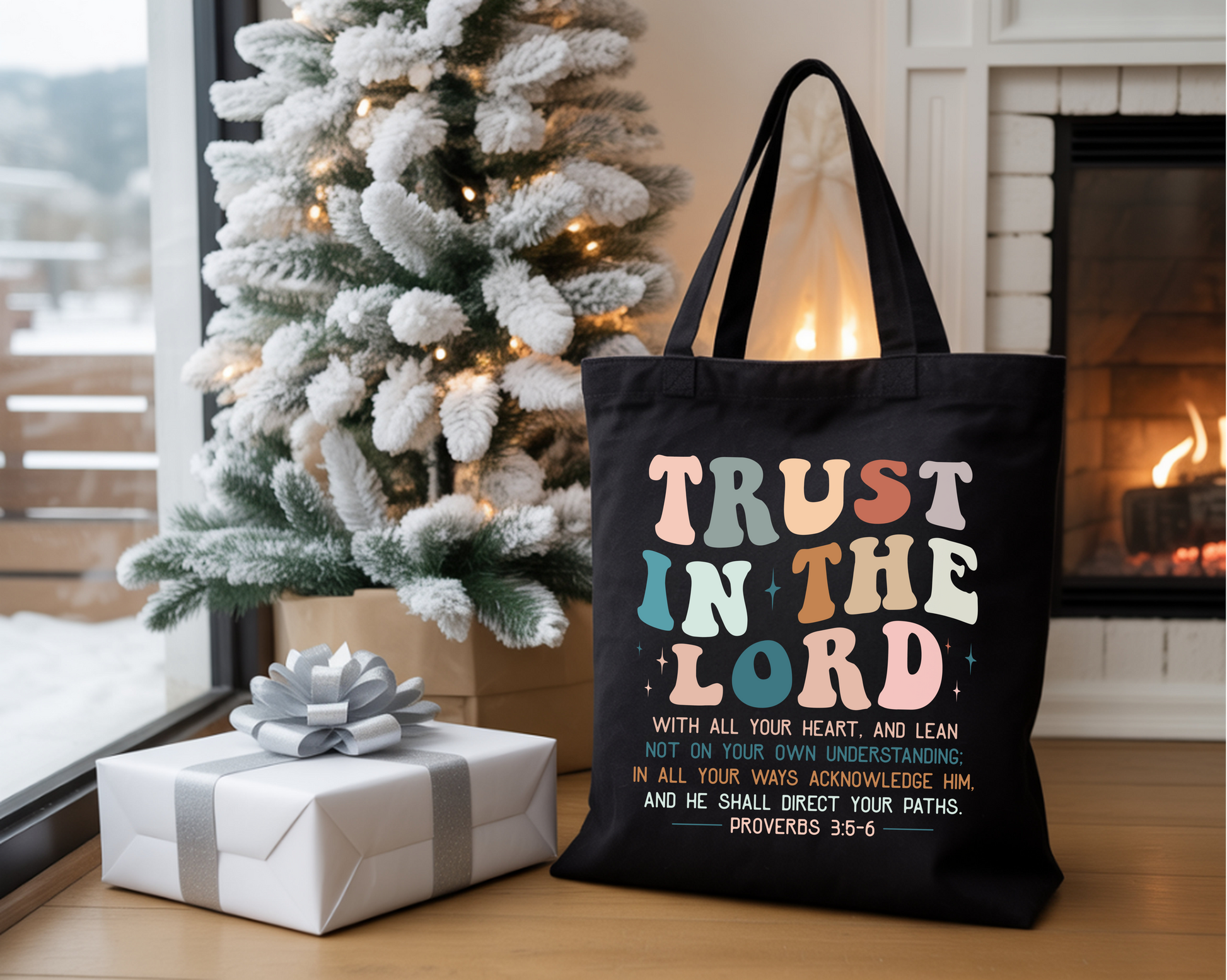 Black tote bag with 'Trust in the Lord' text in a home setting with Christmas tree and presents.