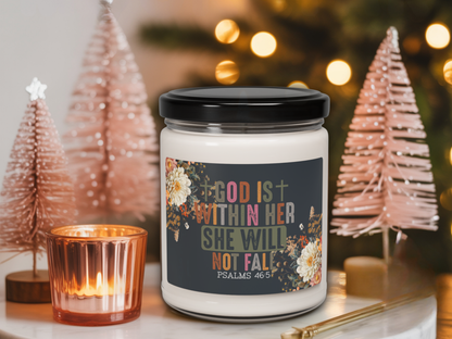 Candle jar with motivational label in a festive setting with Christmas trees and lights.