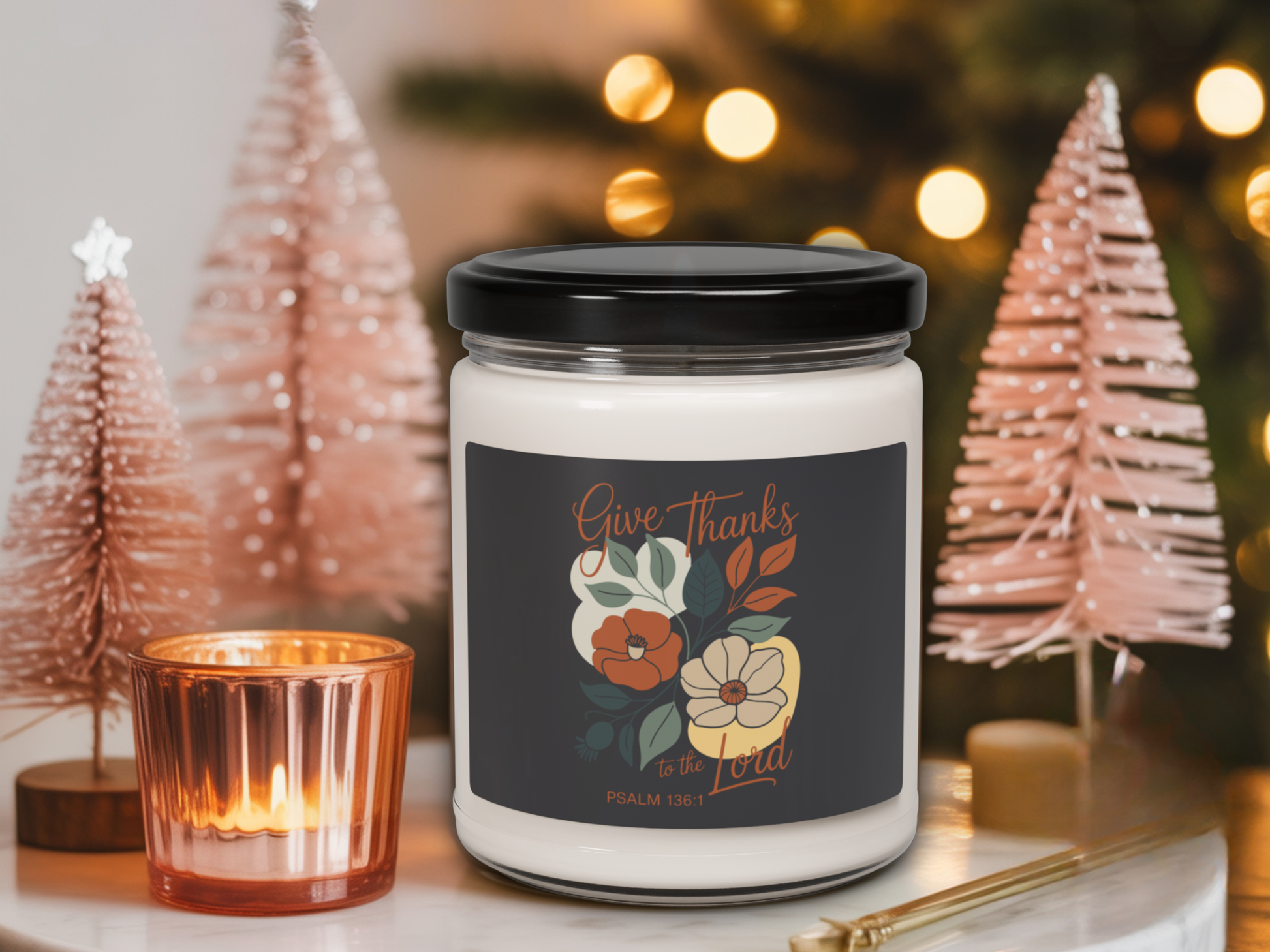 Candle with a decorative label in front of Christmas trees and lights