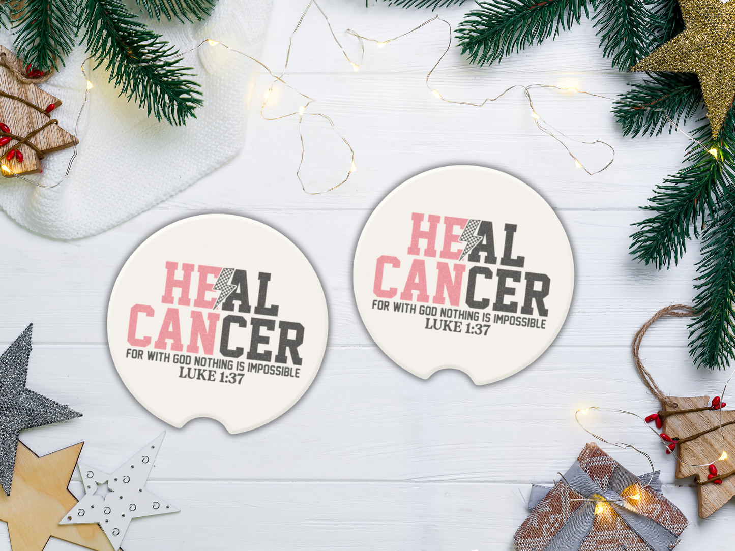Two coasters with 'HEAL CANCER' text on a decorative surface with Christmas elements.