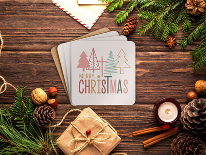 Christmas card with trees and 'Merry Christmas' text on a wooden surface with festive decorations.