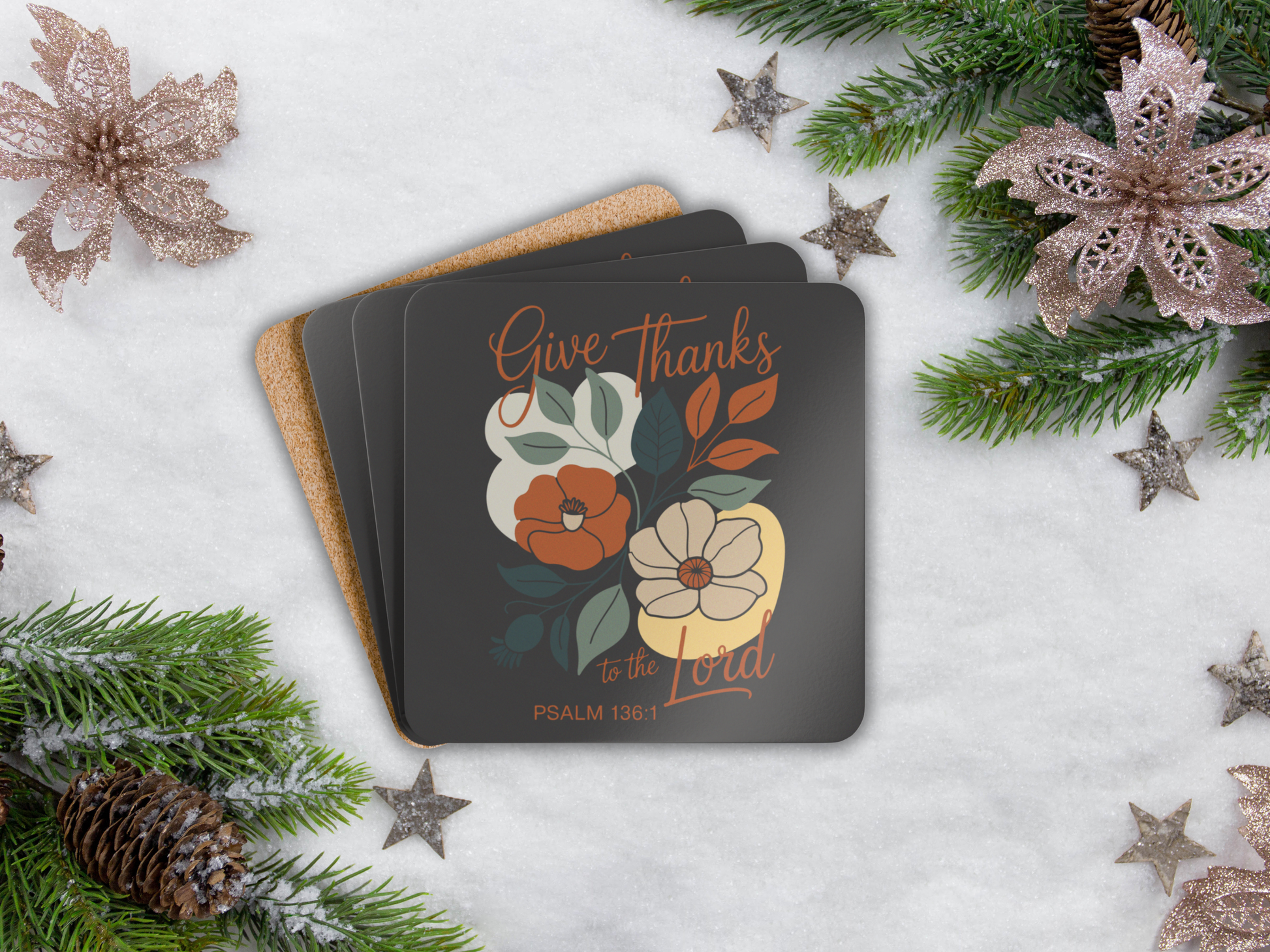 Coasters with floral design and text on a snowy background with Christmas decorations