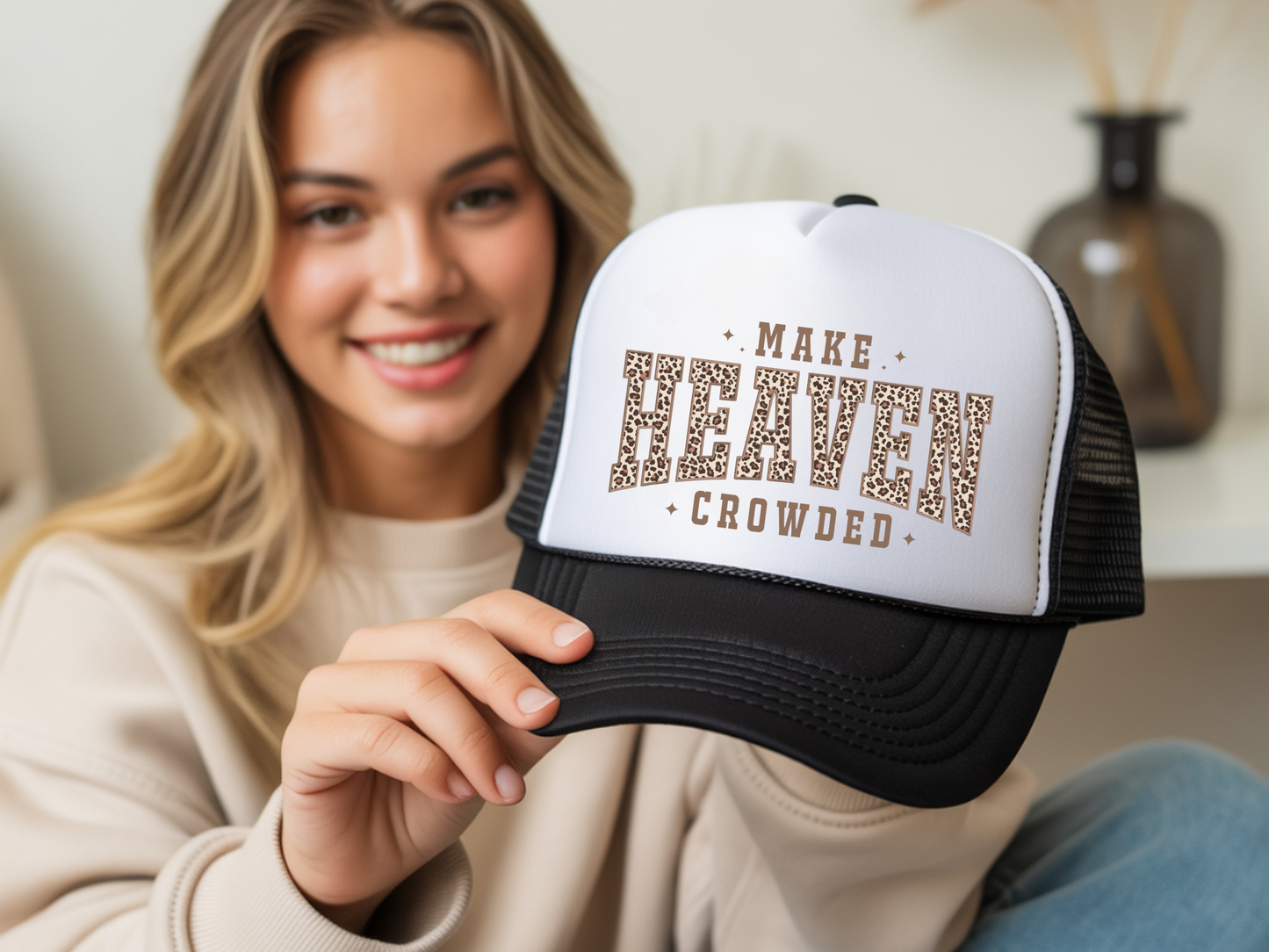 Woman holding a cap with 'Make Heaven Crowded' text