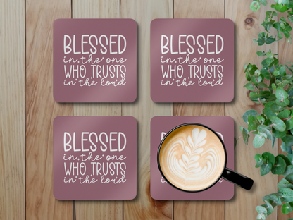 Set of four coasters on a wooden surface with greenery, one holding a latte in a black cup.