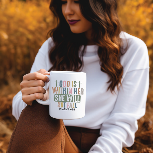 Woman holding a mug with a motivational quote in an autumn setting