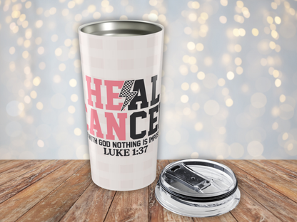 Pink plaid tumbler with motivational quote on a wooden surface with a blurred light background
