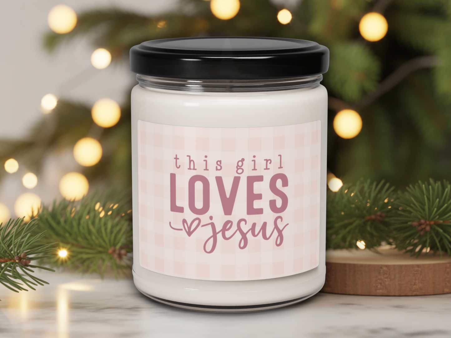 Candle jar with 'this girl LOVES Jesus' text against a festive background