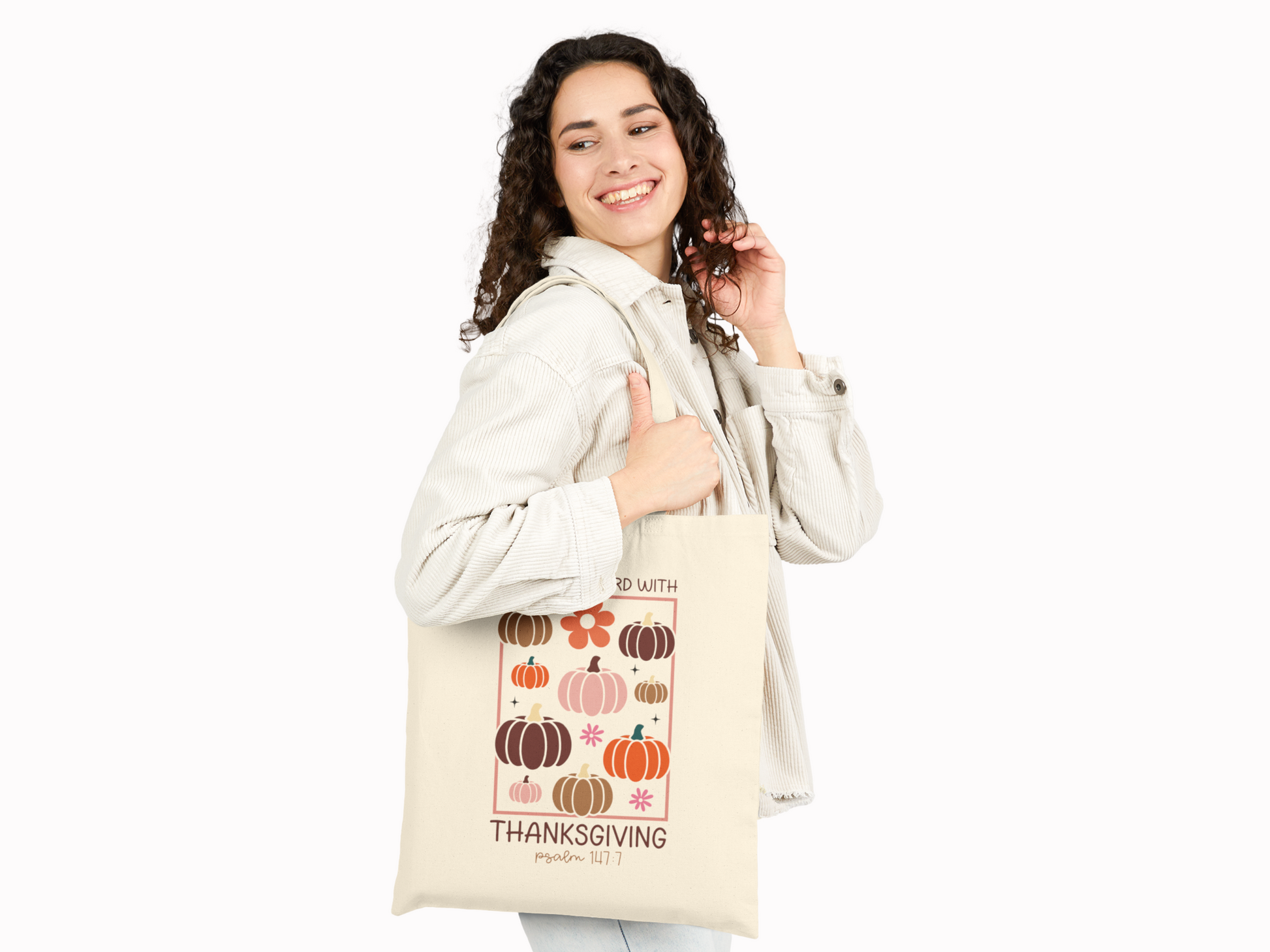 Woman smiling while carrying the scripture tote bag over her shoulder.