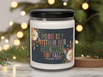 Candle jar with motivational quote against a festive background