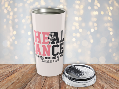 Pink tumbler with motivational quote on a wooden surface with a blurred light background