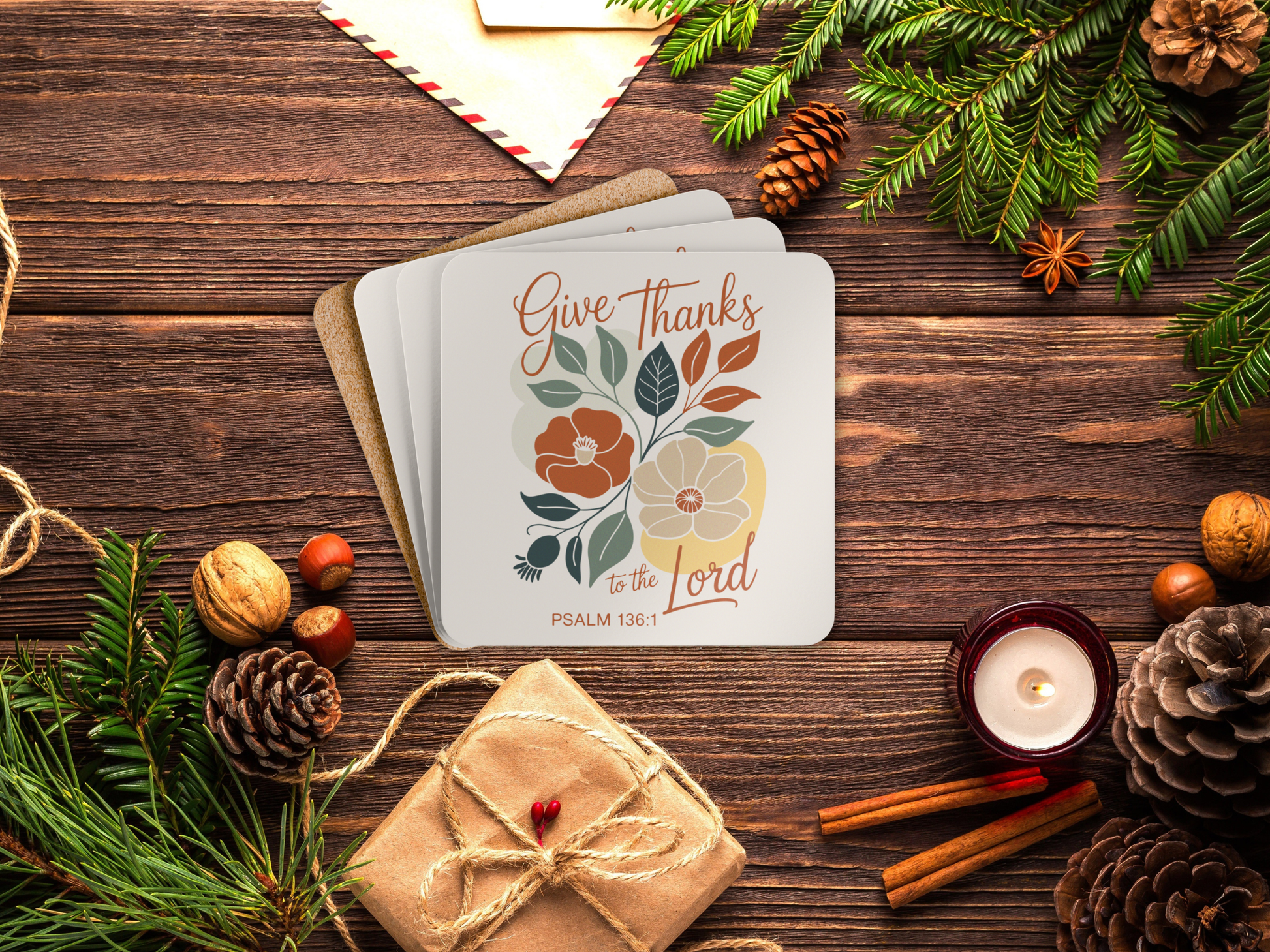 Coaster set with floral design and text on a wooden surface with festive decorations.