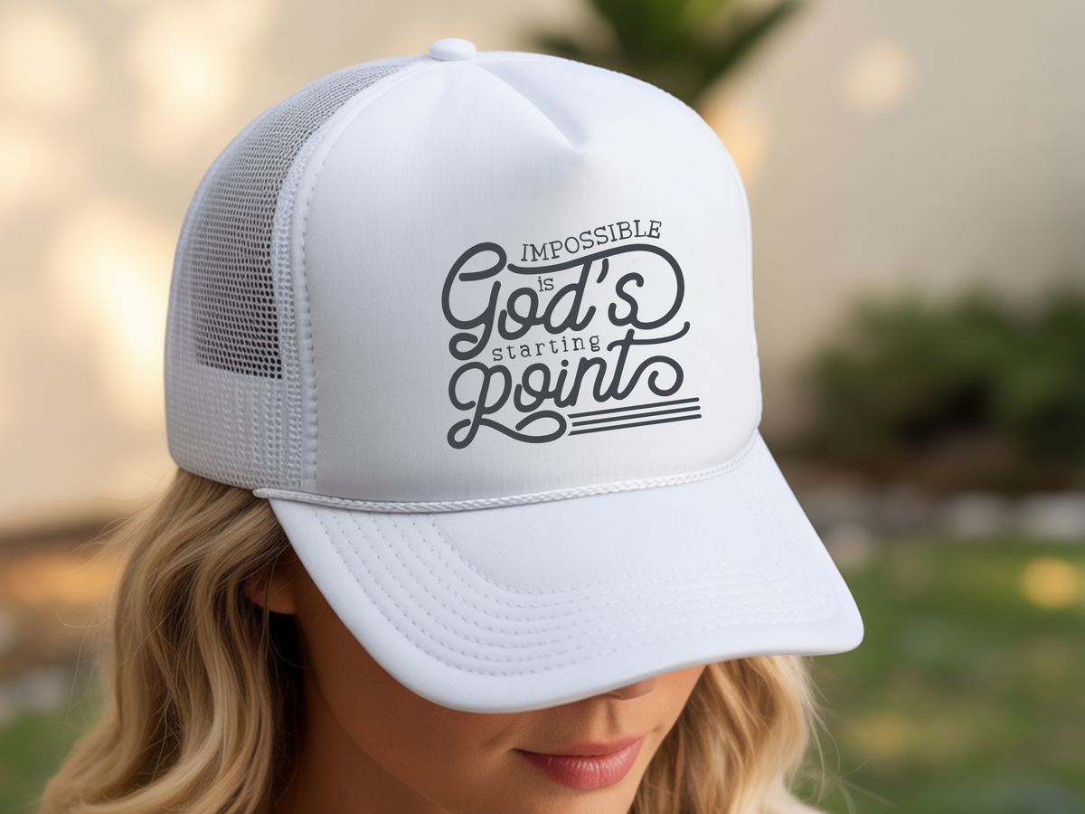 White trucker cap with motivational quote worn by a person outdoors