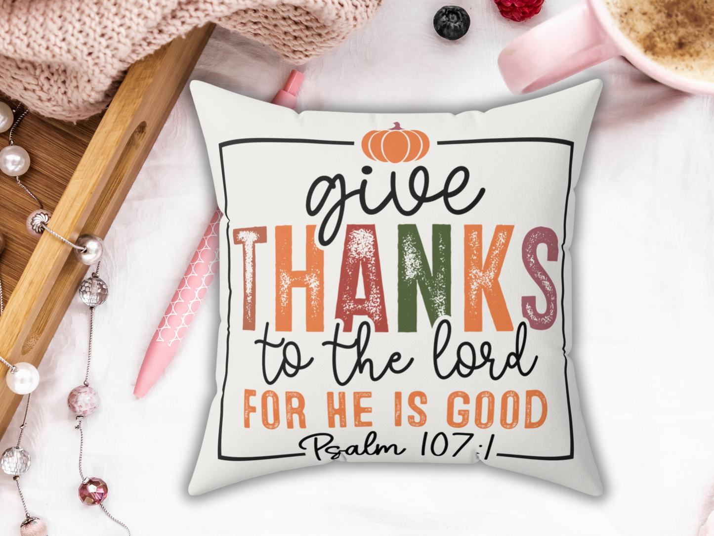 “Give Thanks” scripture pillow styled with pink mug, pearls, and cozy tray decor.