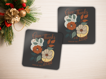 Two coasters with floral design and 'Give Thanks to the Lord' text on a light background.
