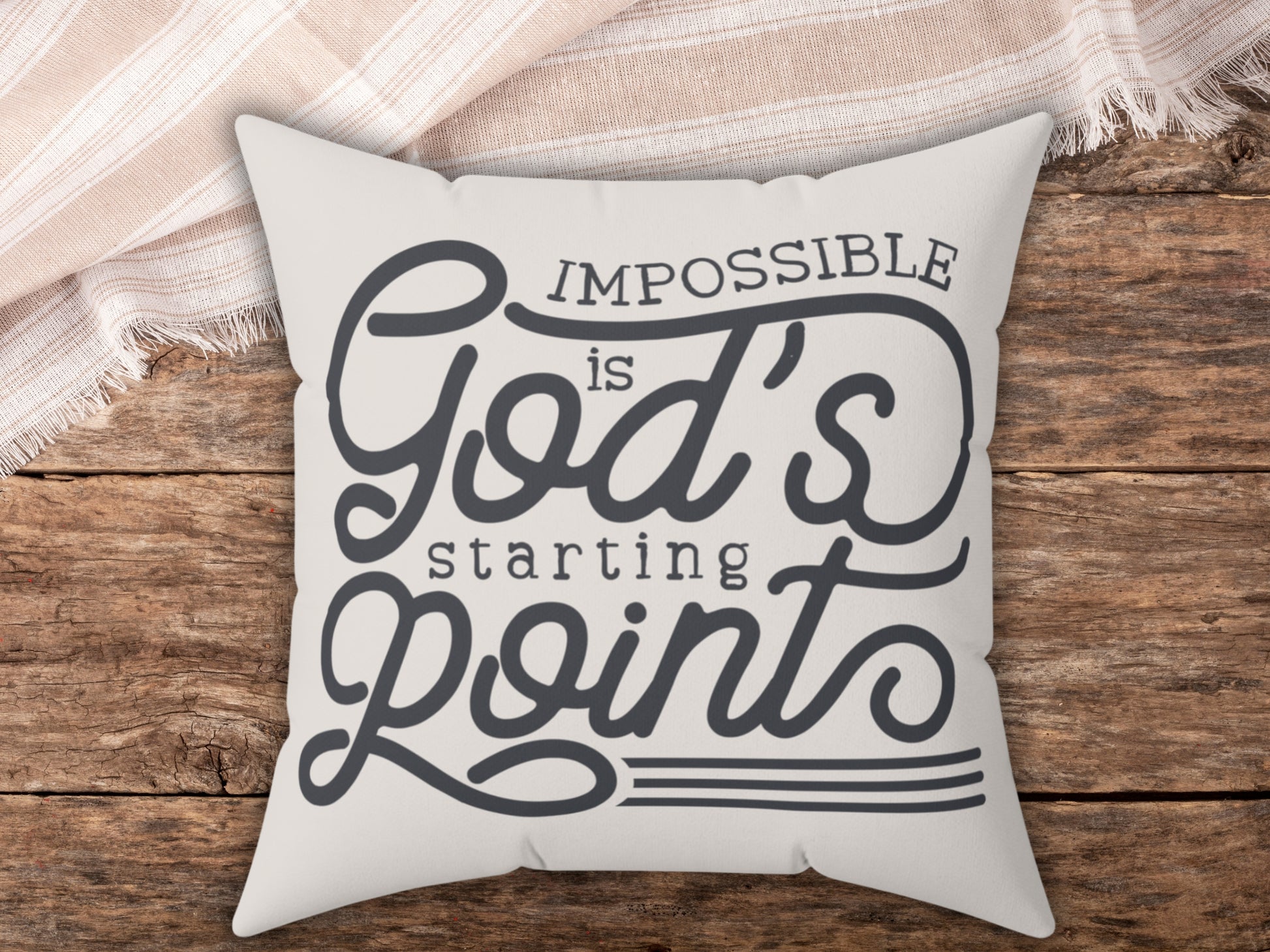 Pillow with motivational quote on a wooden surface