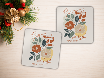Two coasters with floral design and 'Give Thanks to the Lord' text on a light background.