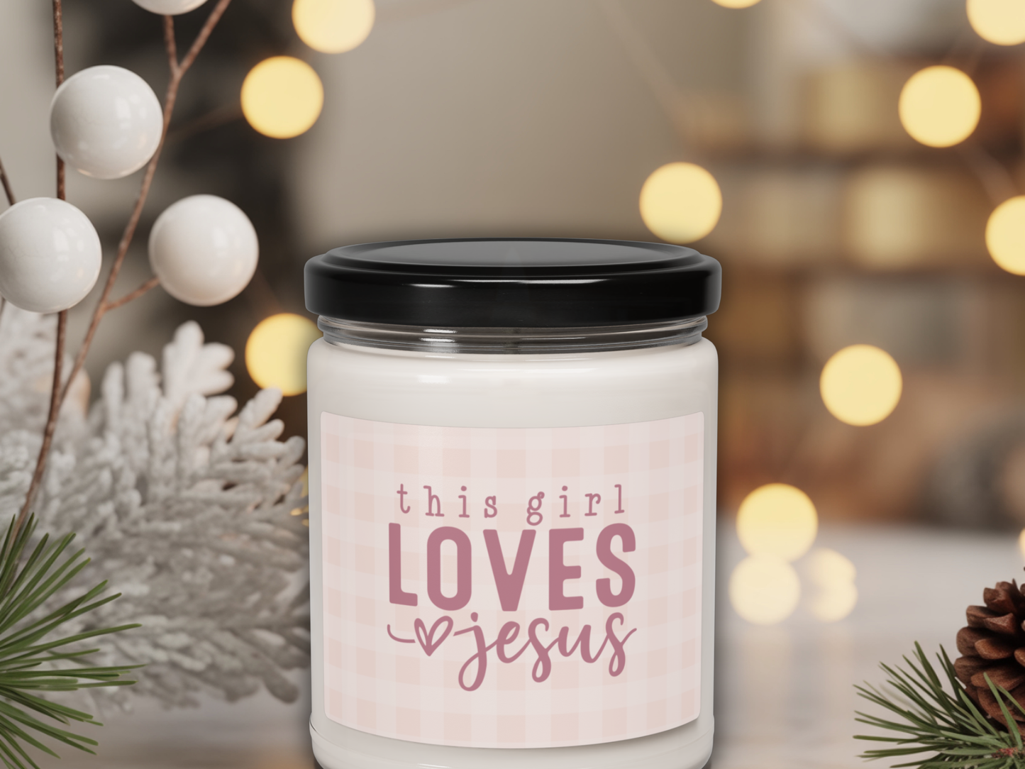 Candle jar with 'this girl loves Jesus' text on a blurred festive background