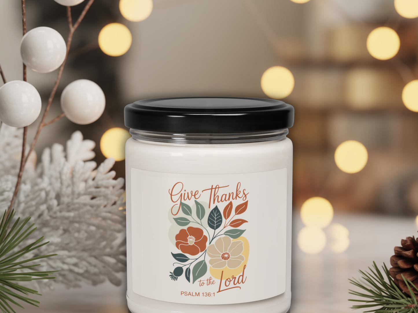 Candle jar with 'Give Thanks to the Lord' label on a blurred background with lights and decorations