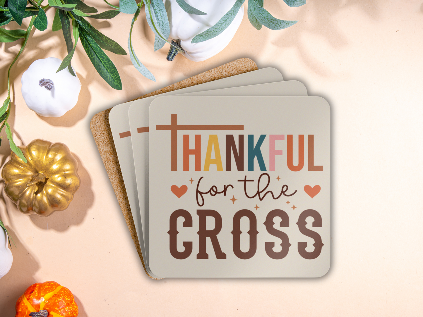 Stack of Christian coasters with cork backing styled among pumpkins and fall greenery for seasonal decor.