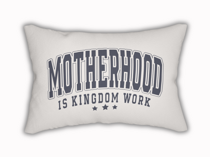 White rectangular pillow with bold navy text reading “Motherhood is Kingdom Work” and three stars beneath.