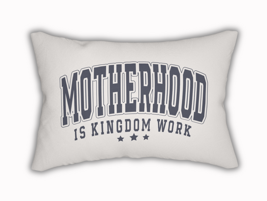 White rectangular pillow with bold navy text reading “Motherhood is Kingdom Work” and three stars beneath.