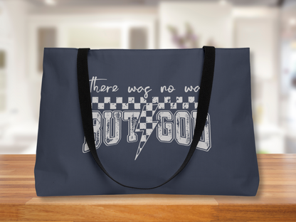 Image Alt Text Generator said:

Navy blue tote bag with “There was no way BUT GOD” design, black straps, displayed on a wooden surface with blurred bright indoor background.