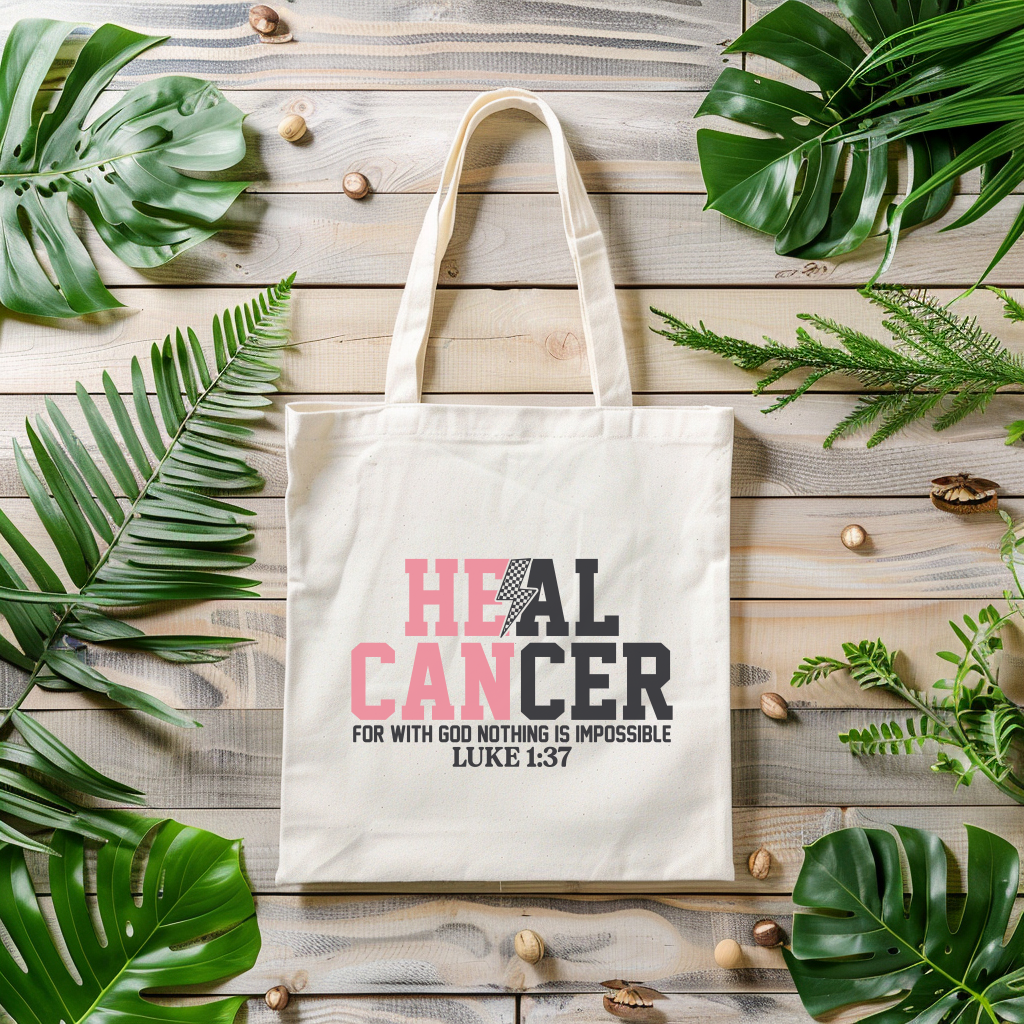 Tote bag with 'HEAL CANCER' text on a wooden surface with leaves