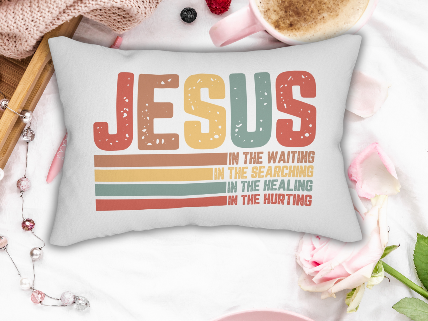 Pillow on a white blanket with coffee, roses, and feminine accents for a soft aesthetic.
