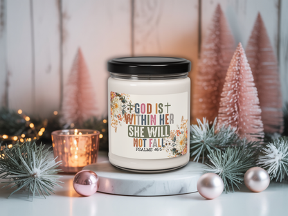 Candle with motivational quote surrounded by Christmas decorations