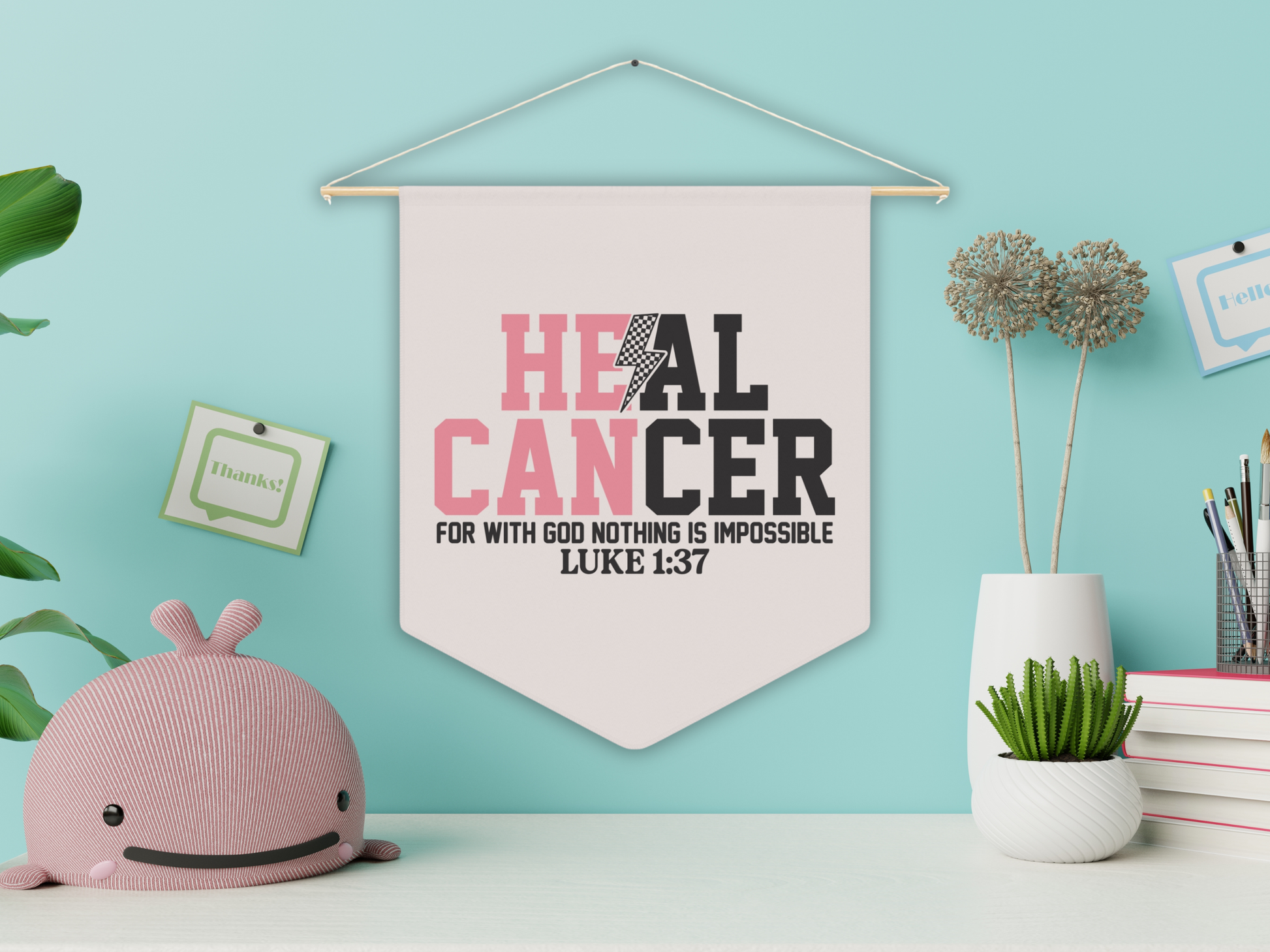 Decorative wall pennant with motivational quote on a light blue wall with decor items.