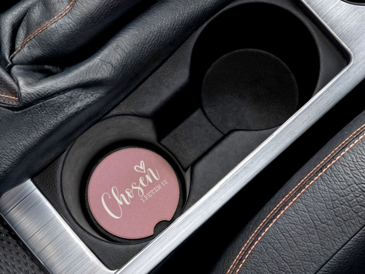 Pink car cup holder coaster with 'Chosen' text in a car's cup holder.
