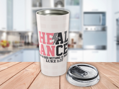 Pink plaid tumbler with motivational quote on a wooden surface in a kitchen setting