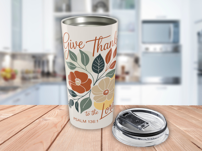Tumbler with floral design and text on a wooden surface in a kitchen setting