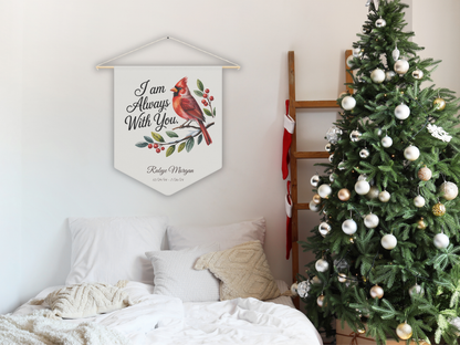 Decorative wall hanging with a cardinal and text next to a Christmas tree in a bedroom.