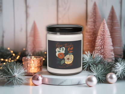 Candle with a decorative label on a table with Christmas decorations