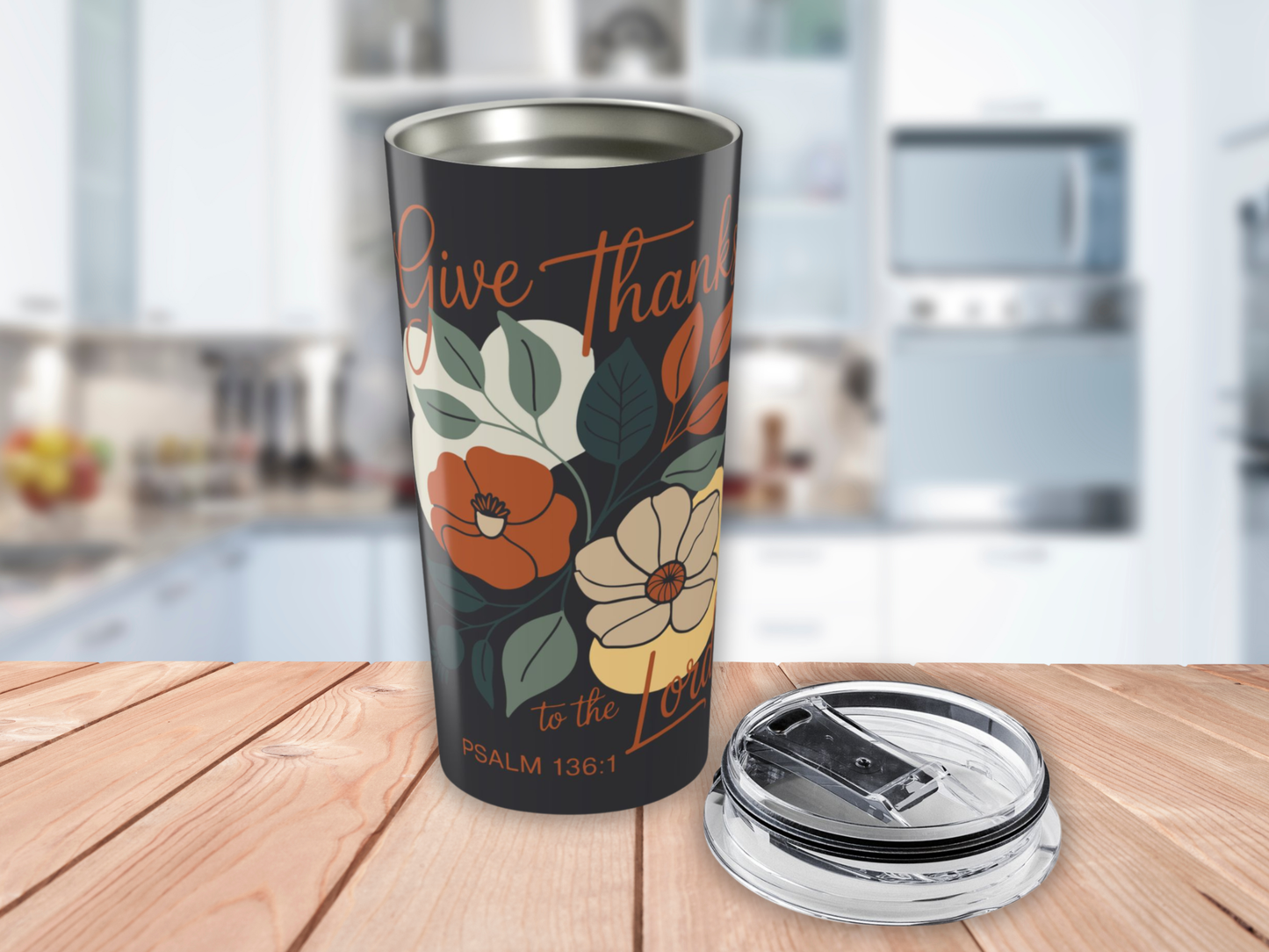 Tumbler with floral design and text on a wooden surface in a kitchen setting