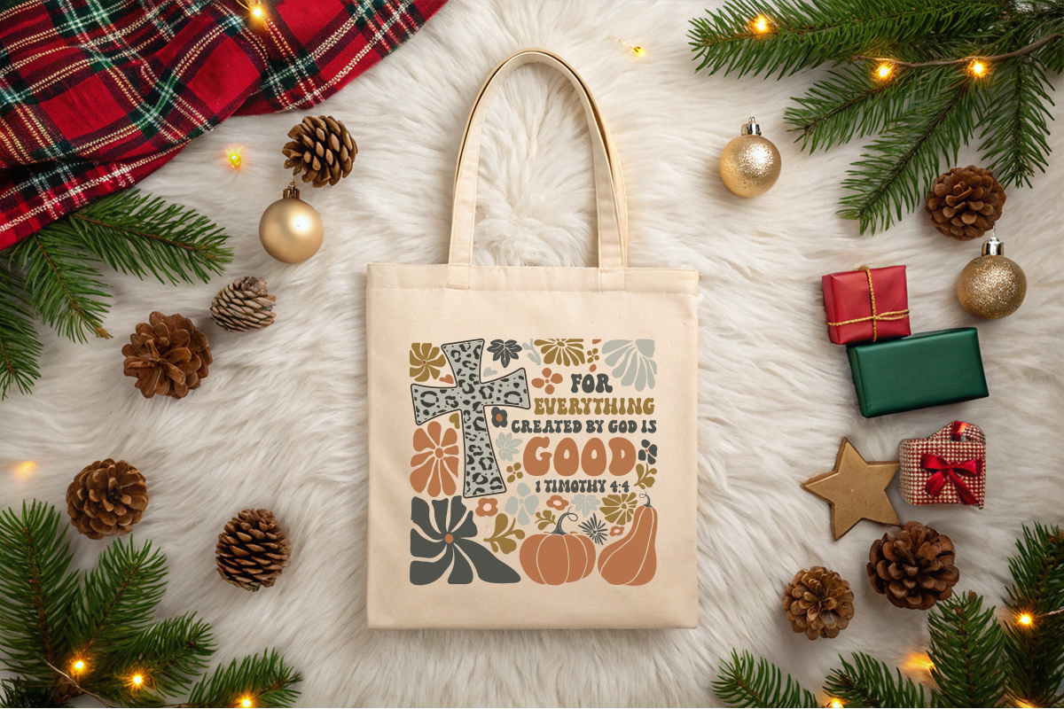 Beige tote bag with decorative text and pumpkins on a festive background with Christmas decorations.