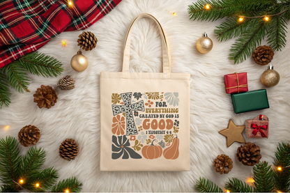 Beige tote bag with decorative text and pumpkins on a festive background with Christmas decorations.