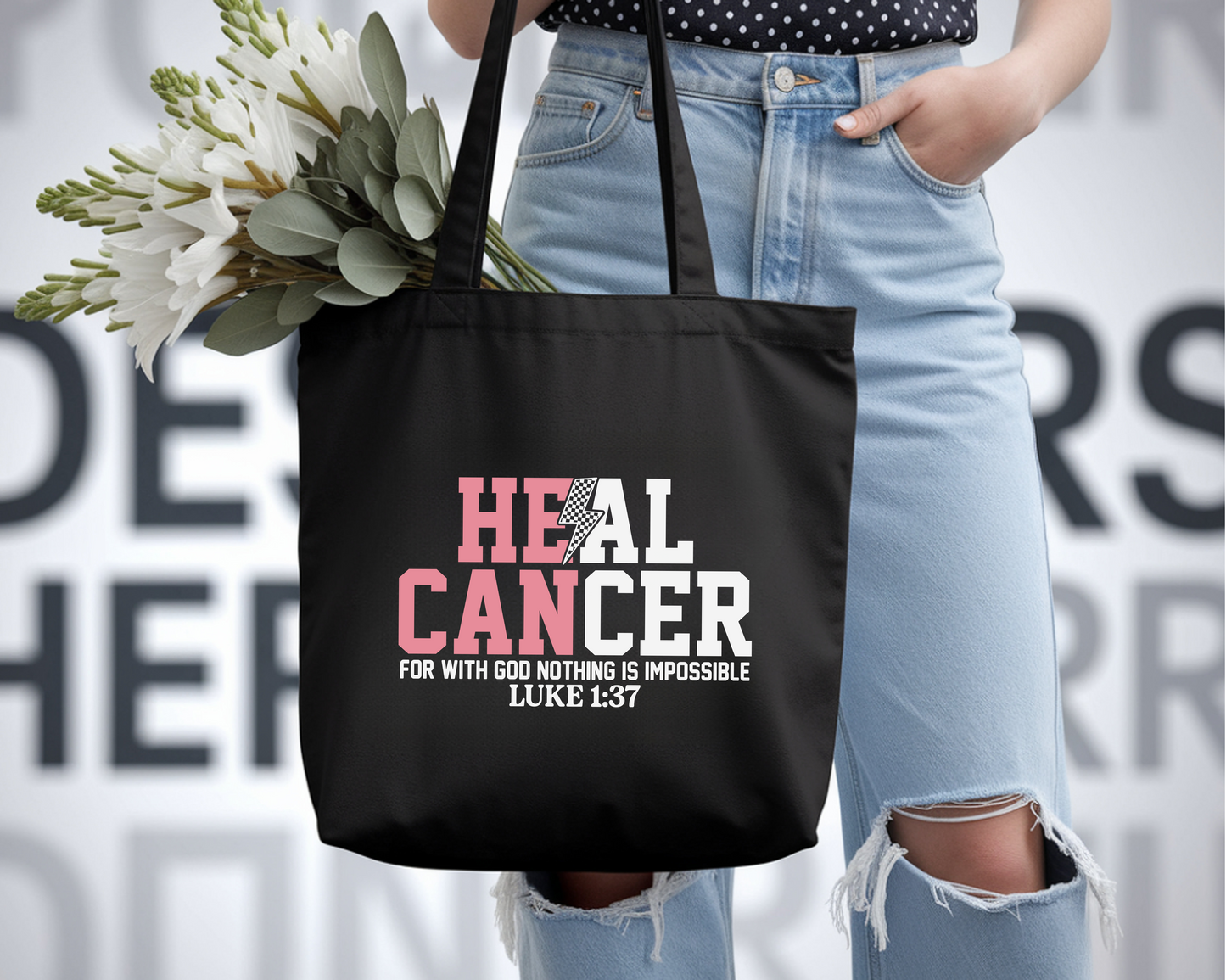 Person holding a black tote bag with 'HEAL CANCER' text, wearing light blue jeans and holding flowers.