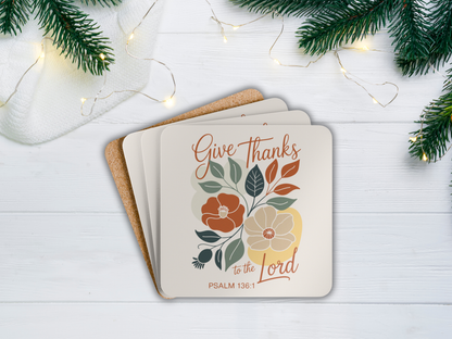 Stack of coasters with floral design and text on a white surface with Christmas decorations.