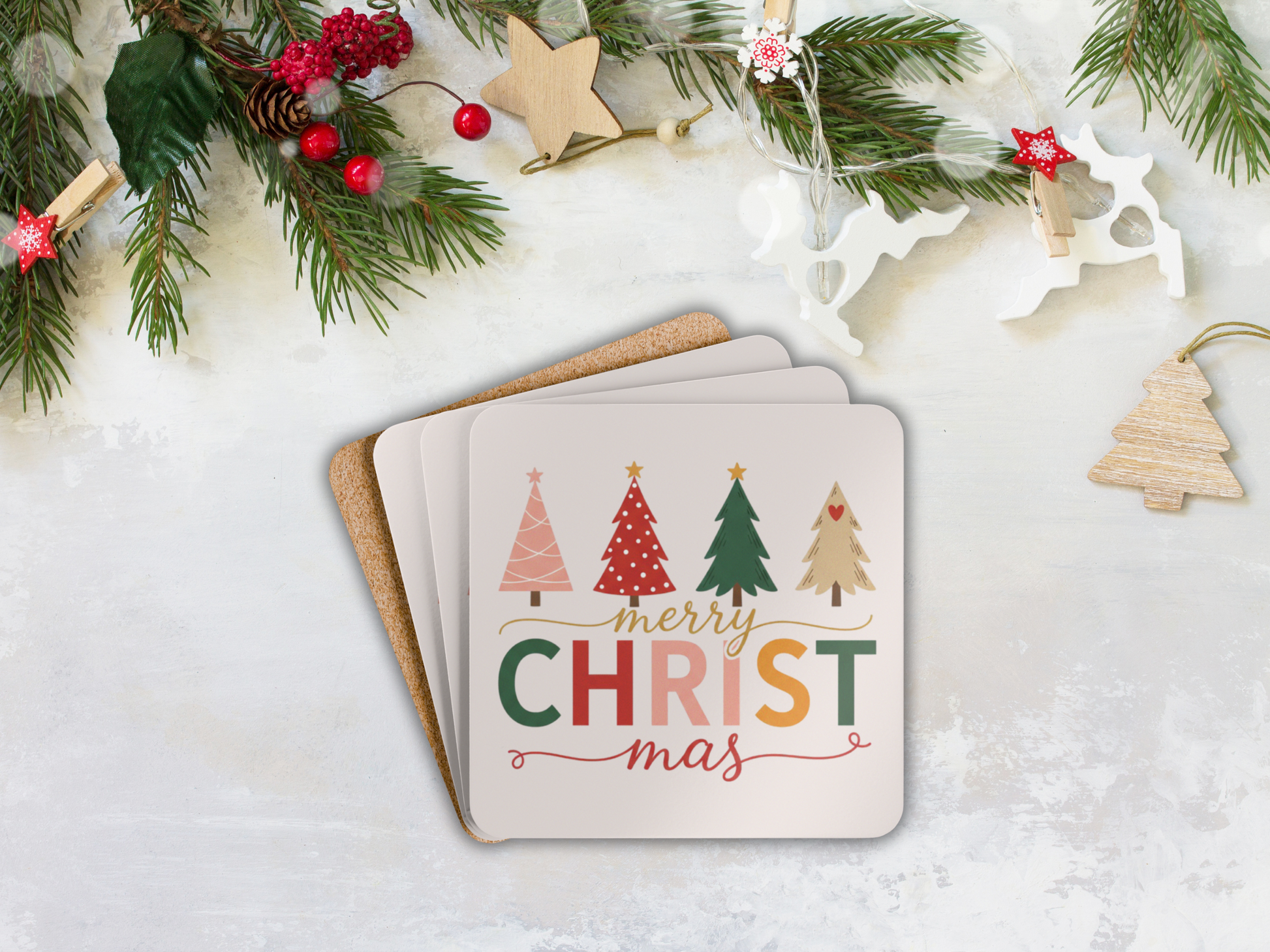 Stack of Christmas-themed coasters with decorative elements on a white surface