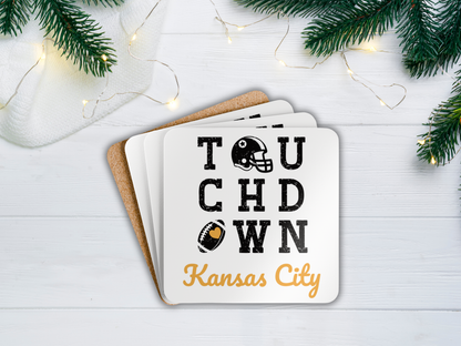 Coasters with 'Touchdown Kansas City' text and football graphics on a white surface with Christmas decorations.