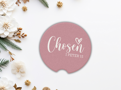 Pink car coaster with 'Chosen 1 Peter 1:2' text on a decorative background with flowers and greenery.