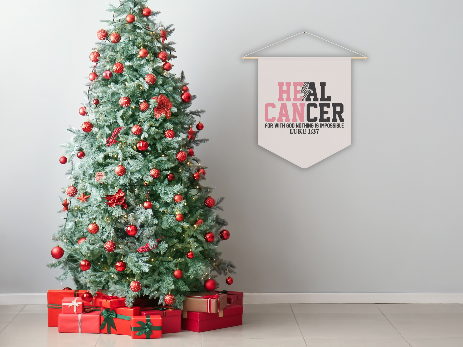 Decorated Christmas tree with red ornaments and presents, leaning against a wall with a 'Heal Cancer' banner.