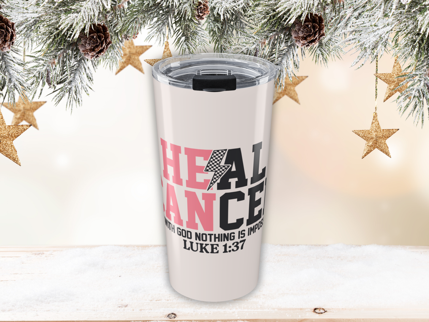 Pink tumbler with motivational quote against a festive background