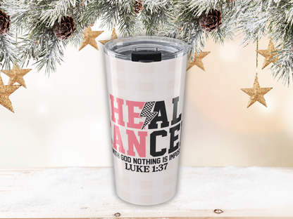 Pink plaid tumbler with motivational quote against a festive background